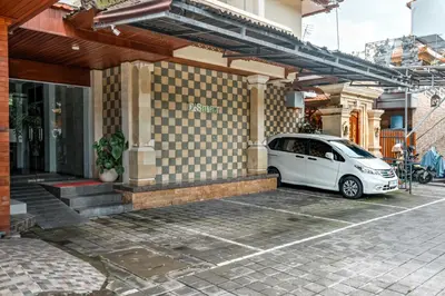 a white car parked outside of a building at D Sarian Seminyak in Seminyak