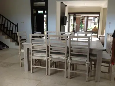 a wooden table with chairs and a dining room at Villa Indah Kuta Royal - Private Pool - Optic Fiber High Speed Internet in Kuta