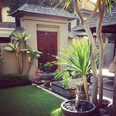 a house with a bunch of plants in front of it at Villa Indah Kuta Royal - Private Pool - Optic Fiber High Speed Internet in Kuta