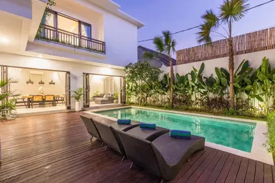 a swimming pool in the middle of a house at Villa Azura in Seminyak