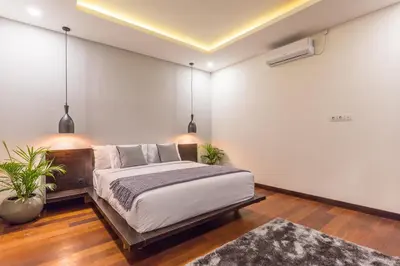 a bedroom with a large bed and a rug at Villa Azura in Seminyak
