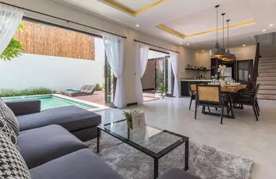 a living room with a couch and a table at Villa Azura in Seminyak