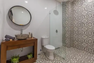 a bathroom with a toilet and a sink and a mirror at Villa Azura in Seminyak