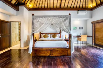 a bedroom with a bed with a canopy at Modern Private Villa Atala with Private XL Pool in Seminyak