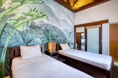 two beds in a room with a mural at Modern Private Villa Atala with Private XL Pool in Seminyak