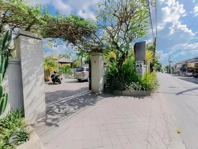 a gate to a street with a car parked on the street at The Lavana Arimanu Kuta in Kuta
