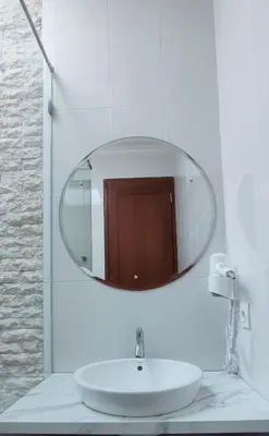 a bathroom with a white sink and a mirror at Pondok DenAyu Homestay in Kuta