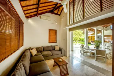a living room with a couch and a table at Villa Maharaj in Seminyak