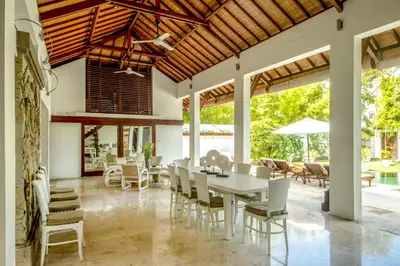 a dining room with a table and chairs at Villa Maharaj in Seminyak