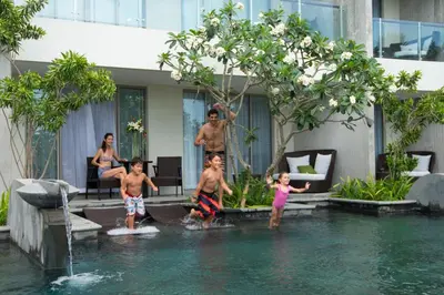 a group of children playing in the water in a pool at RIMBA by AYANA Bali in Jimbaran