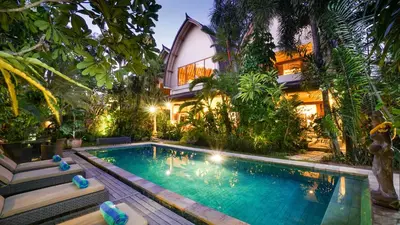 a villa with a swimming pool in front of a house at Villa Bali Maja - Beautiful Private Pool Villa in Petitenget, Seminyak in Seminyak