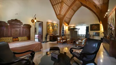 a bedroom with a bed and a table and chairs at Villa Bali Maja - Beautiful Private Pool Villa in Petitenget, Seminyak in Seminyak