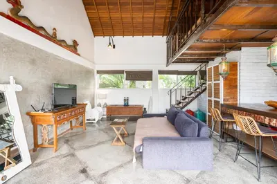 a living room with a couch and a desk at Lolo #2 Apartment by Betterplace in Canggu