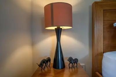 a lamp on a wooden table with two horses on it at Villa Seacluded 1 - 3BR Villa in Central Seminyak - Large Pool in Seminyak