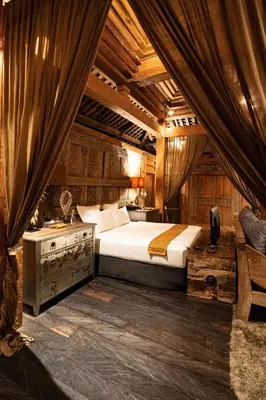 a bedroom with a bed and a desk in it at Villa Jasli in Canggu