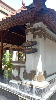 a street sign on the side of a building at Simple Kuta Bedroom in Kuta