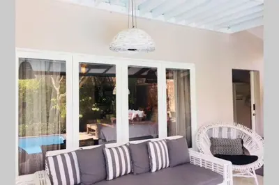a living room with a couch and some chairs at Villa Bloom 4 - 2 King bedrooms , Sleep 4 Pax, private pool, Seminyak in Seminyak