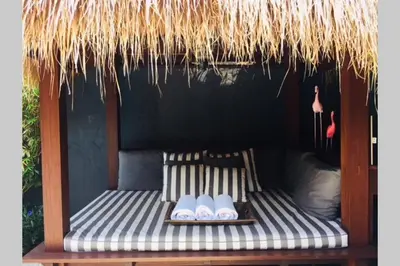 a bed with a straw roof with three bowls on it at Villa Bloom 4 - 2 King bedrooms , Sleep 4 Pax, private pool, Seminyak in Seminyak