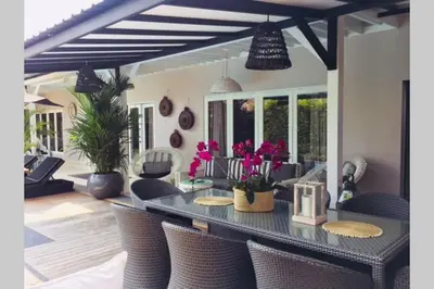 a dining room with a table and chairs at Villa Bloom 4 - 2 King bedrooms , Sleep 4 Pax, private pool, Seminyak in Seminyak