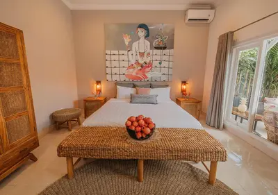 a bedroom with a bed with a bowl of fruit on a table at Villa Bloom 5 close to the beach private pool 3 bedrooms 3 bathrooms in Seminyak