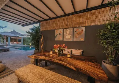 a living room with a wooden table with flowers on it at Villa Bloom 5 close to the beach private pool 3 bedrooms 3 bathrooms in Seminyak