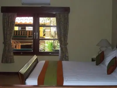 a bedroom with a bed and a window at Apel Villa Sanur in Sanur