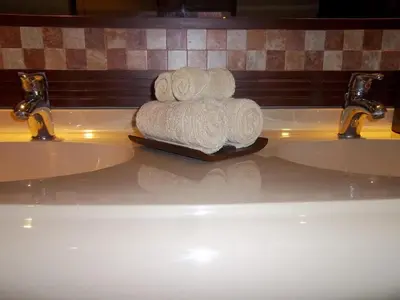 a pile of towels sitting on top of a bathroom sink at Apel Villa Sanur in Sanur
