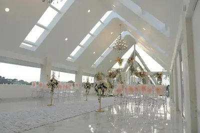 a banquet hall with tables and chairs and flowers at Tirtha Khayangan in Canggu