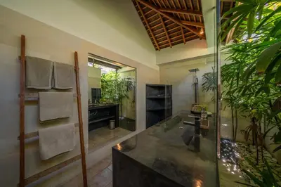 a bathroom with a shower and a sink and a mirror at Villa Teman - Luxury 4BR Villa in Central Seminyak - HUGE POOL in Seminyak
