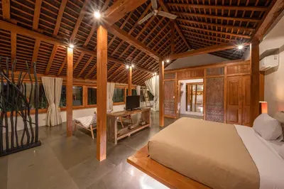 a bedroom with a bed and a tv in a room at Villa Teman - Luxury 4BR Villa in Central Seminyak - HUGE POOL in Seminyak