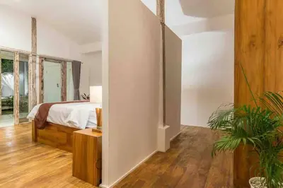 a bedroom with a bed and a potted plant at Villa Alegria in Seminyak