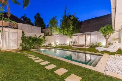 a swimming pool in the yard of a house at Villa Alegria in Seminyak