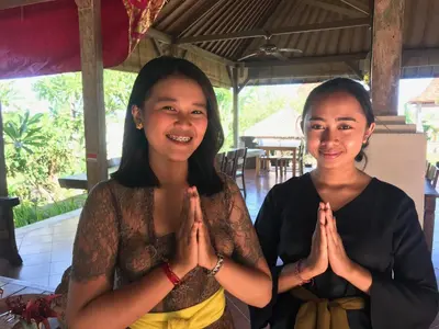 two women are sitting in a praying gesture at Bali Eco Living Yoga Healing Meditation and Retreat Center in Denpasar
