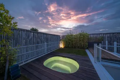 a large green bath tub sitting on a deck at Villa Tykhe - Modern Balinese 4BR Pool Villa in Central Seminyak in Seminyak