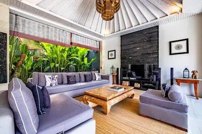 a living room with a couch and a table at Central Seminyak Villa Martini in Seminyak