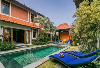 a house with a swimming pool in front of a house at Listien Villa N3 in Seminyak