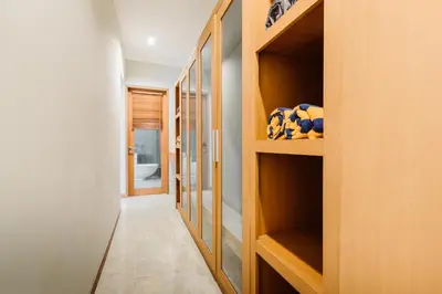 a hallway with wooden shelves in a house at Listien Villa N3 in Seminyak