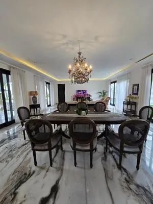 a dining room with a table and chairs and a chandelier at Villa Akasha Luxury 6 bedroom villa near beach in Canggu