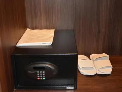 a black microwave with a book on top of it at Ramada by Wyndham Bali Sunset Road Kuta in Kuta