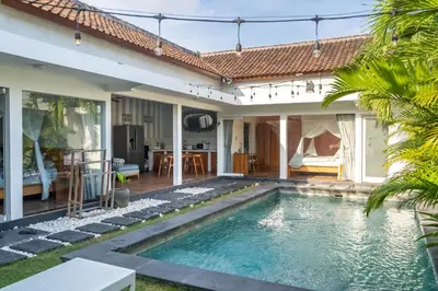 a swimming pool in the backyard of a house at La Fortuna in Seminyak