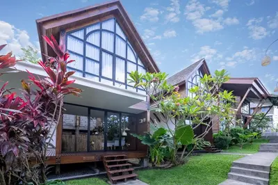 a house with a lot of windows and plants at Atra Bambulogy Villa by Bambulogy Resort in Kerobokan
