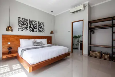 a bedroom with a large bed and a mirror at Villa Voyage 4 in Seminyak