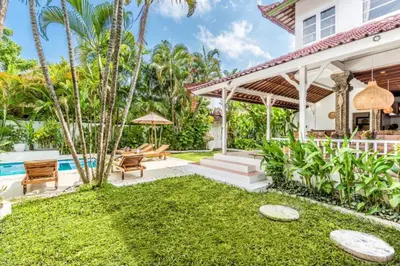 a backyard with a pool and a house at Villa Berlin - Private 6 BDR Villa in Seminyak with Pool and Garden in Seminyak