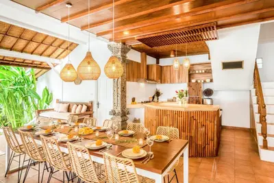 an open kitchen and dining room with a table and chairs at Villa Berlin - Private 6 BDR Villa in Seminyak with Pool and Garden in Seminyak