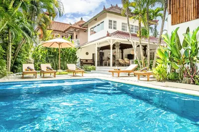 a swimming pool in front of a house with a villa at Villa Berlin - Private 6 BDR Villa in Seminyak with Pool and Garden in Seminyak