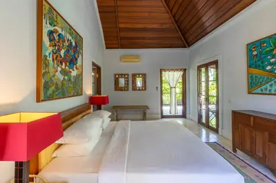 a bedroom with a large white bed in a room at Villa Angsa by Nakula in Sanur