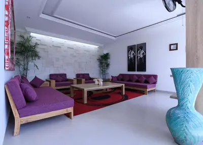 a living room with purple couches and a table at Bali Villas Arta in Seminyak