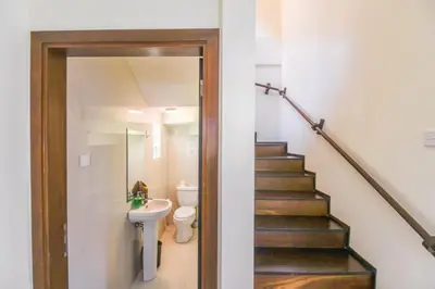 a bathroom with a toilet and a sink and a staircase at Amalia Swan Haven Villa Seminyak in Seminyak