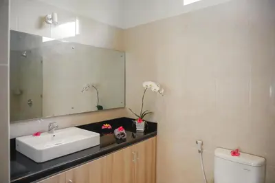 a bathroom with a sink and a mirror at Villa 66, 5 min walk to Double 6 beach in Seminyak