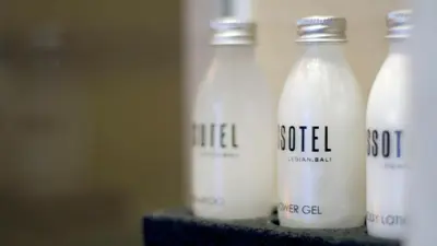 three bottles of milk sitting on a shelf at Ossotel Legian in Legian